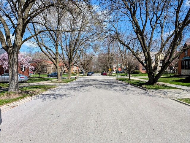 9018 S Oakley Ave, Chicago, IL 60643 - view of asphalt street with curbs, sidewalks, a residential view, and traffic signs