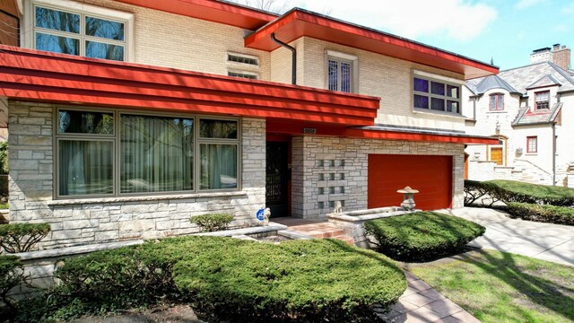 9018 S Oakley Ave, Chicago, IL 60643 - view of front facade with stone siding and an attached garage
