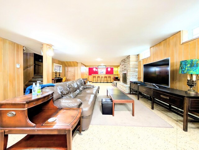 9018 S Oakley Ave, Chicago, IL 60643 - living room featuring wooden walls, a fireplace, stairway, and speckle patterned floor