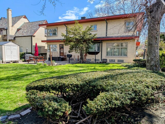 9018 S Oakley Ave, Chicago, IL 60643 - back of property featuring a patio area, brick siding, a yard, and a chimney