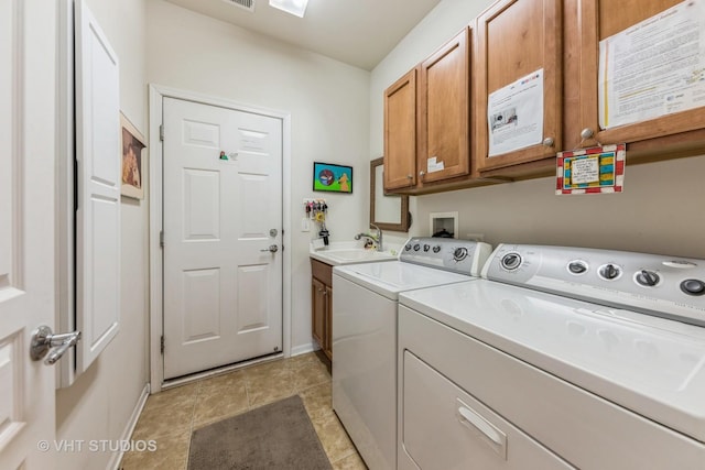 clothes washing area with cabinets, separate washer and dryer, and sink