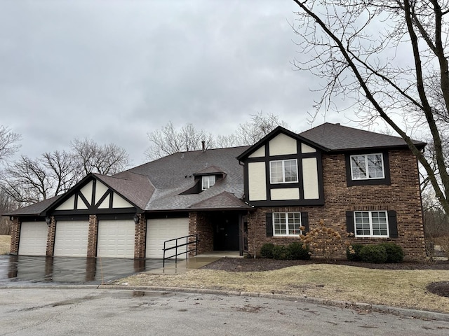 tudor house featuring a garage