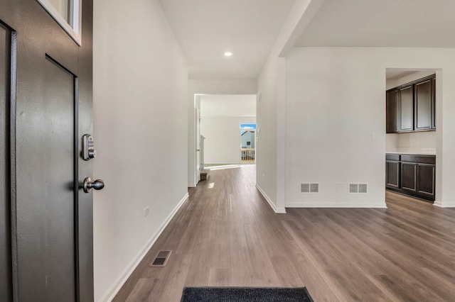 hallway with hardwood / wood-style floors