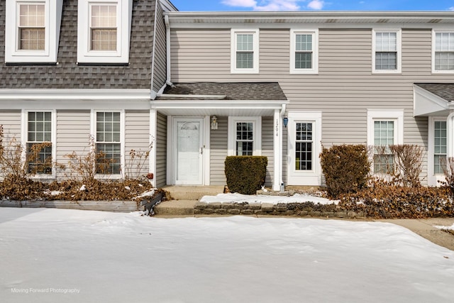 multi unit property featuring a shingled roof