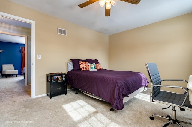 carpeted bedroom with visible vents, a ceiling fan, and baseboards