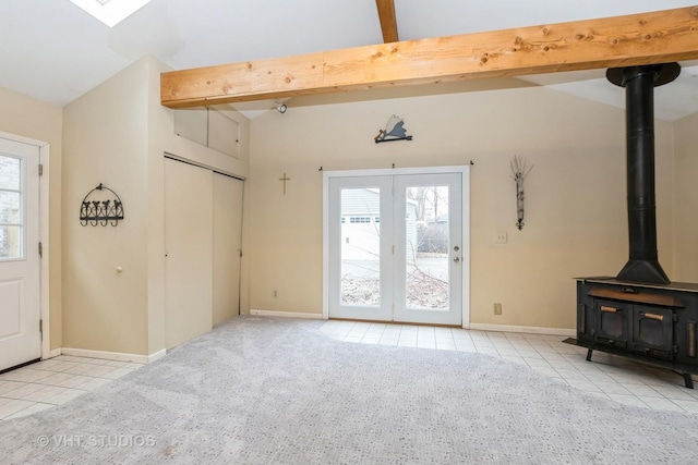 tiled living room featuring lofted ceiling with beams and a wood stove