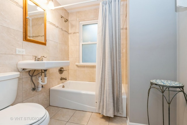 full bathroom featuring tile walls, tile patterned floors, shower / bath combination with curtain, and toilet