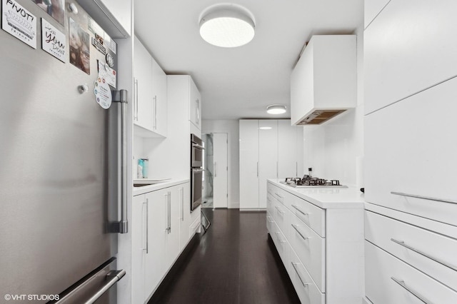 kitchen featuring white cabinetry, dark hardwood / wood-style flooring, and appliances with stainless steel finishes