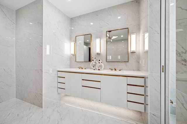 bathroom featuring vanity and tile walls