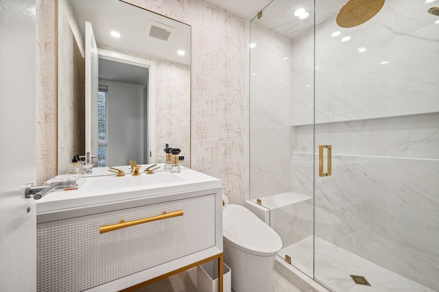 bathroom with vanity, a shower with shower door, and toilet