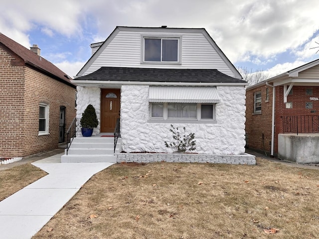 bungalow-style home with a front yard