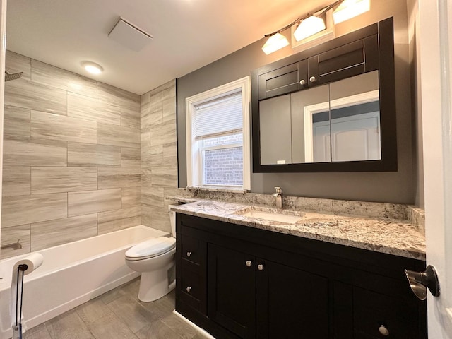 full bathroom with vanity, tiled shower / bath combo, wood-type flooring, and toilet