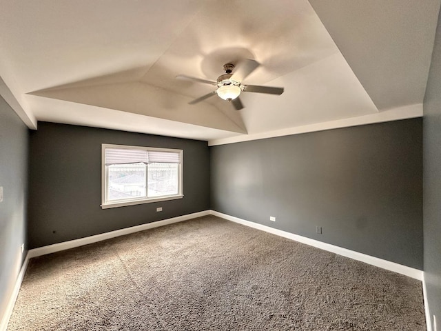 carpeted spare room featuring ceiling fan and vaulted ceiling