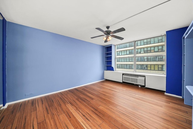 empty room with wood-type flooring and ceiling fan