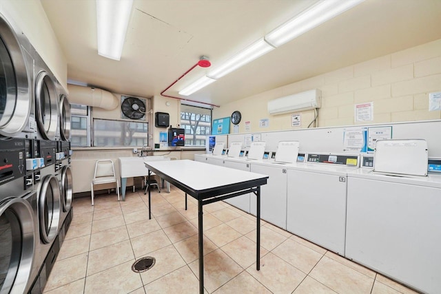 washroom featuring stacked washer and dryer, sink, washing machine and dryer, light tile patterned flooring, and an AC wall unit