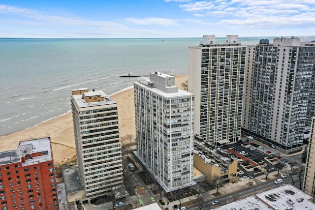 drone / aerial view featuring a beach view and a water view