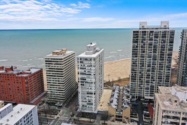 birds eye view of property featuring a water view and a view of the beach