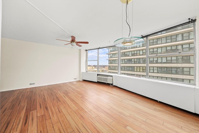 unfurnished living room with ceiling fan and light hardwood / wood-style flooring