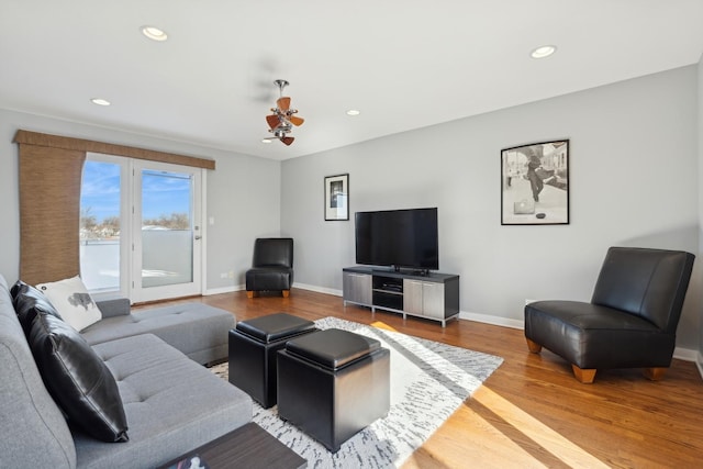 living area featuring a ceiling fan, baseboards, wood finished floors, and recessed lighting