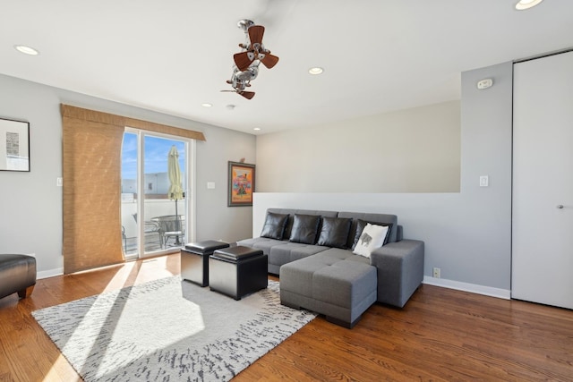 living room featuring recessed lighting, ceiling fan, baseboards, and wood finished floors