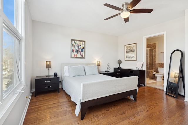 bedroom featuring wood finished floors, a ceiling fan, and connected bathroom