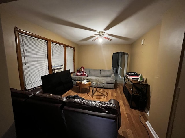 living room featuring hardwood / wood-style flooring, ceiling fan, and cooling unit