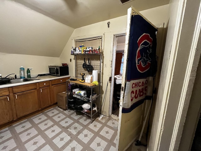 kitchen with lofted ceiling and sink