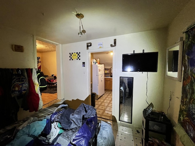 bedroom with white refrigerator