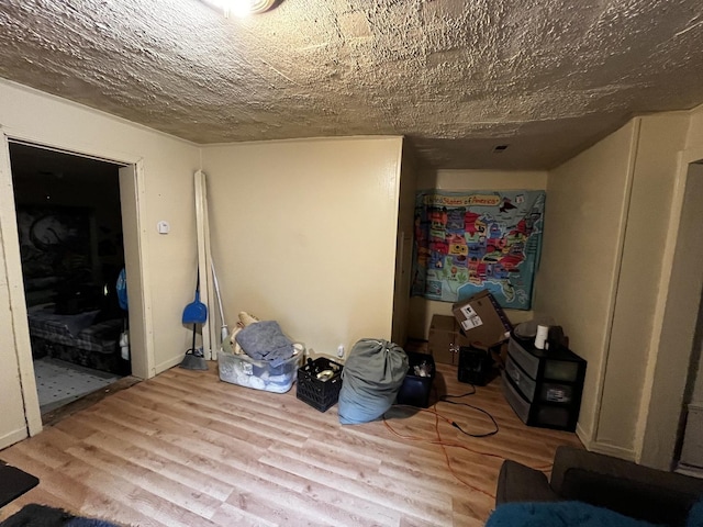 bedroom with a textured ceiling and light wood-type flooring