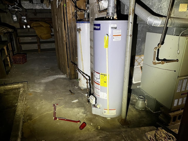 utility room with heating unit and water heater