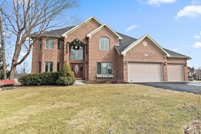 view of front of house featuring a garage, a front lawn, aphalt driveway, and brick siding