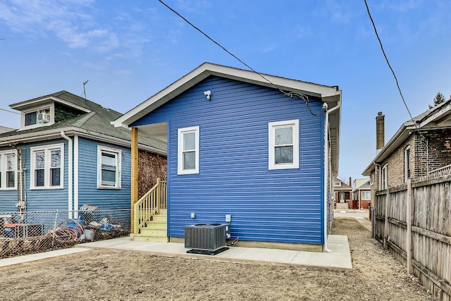 rear view of property featuring central AC unit