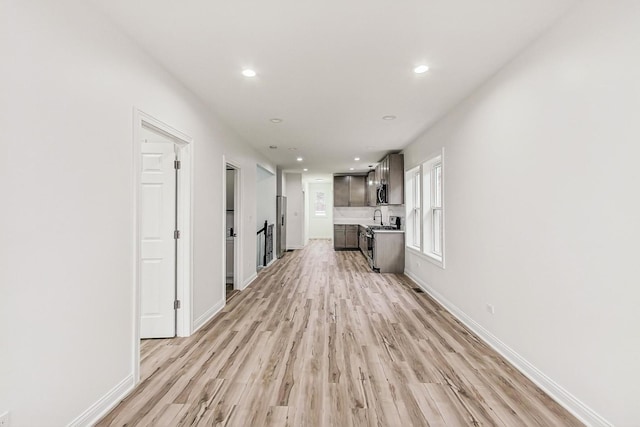 hallway with light hardwood / wood-style floors