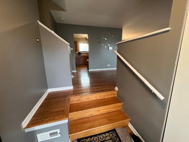 stairs featuring wood-type flooring