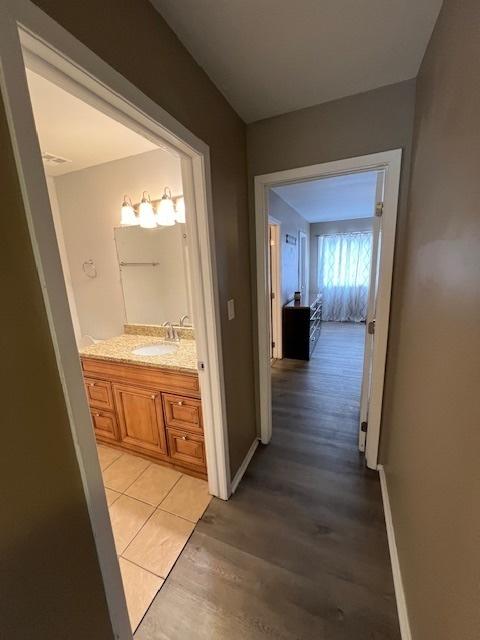 hall featuring sink and light hardwood / wood-style flooring