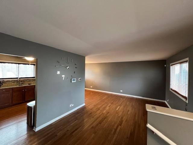 empty room with dark hardwood / wood-style floors and sink