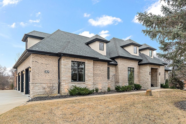 french country inspired facade with a garage and a front lawn