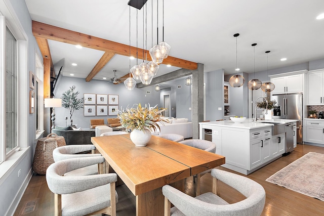 dining area with dark hardwood / wood-style flooring, sink, beamed ceiling, and ceiling fan