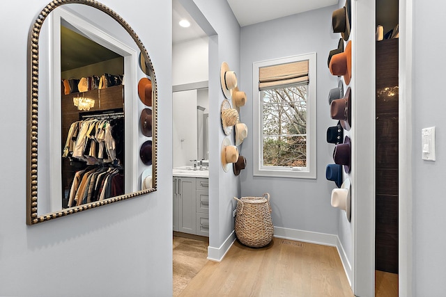 interior space featuring sink and light hardwood / wood-style flooring