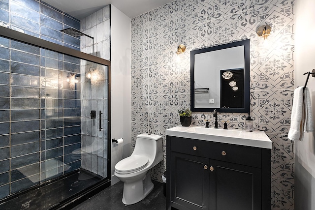 bathroom featuring vanity, tiled shower, and toilet