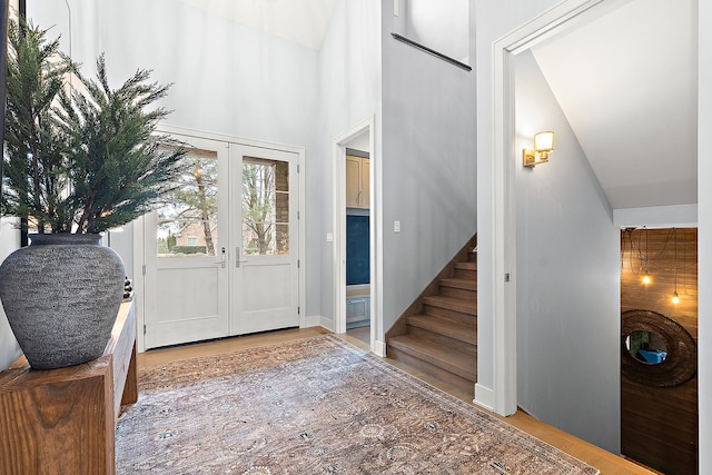 foyer entrance featuring hardwood / wood-style floors and french doors