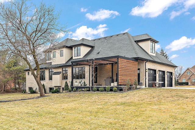 rear view of house featuring a garage and a lawn