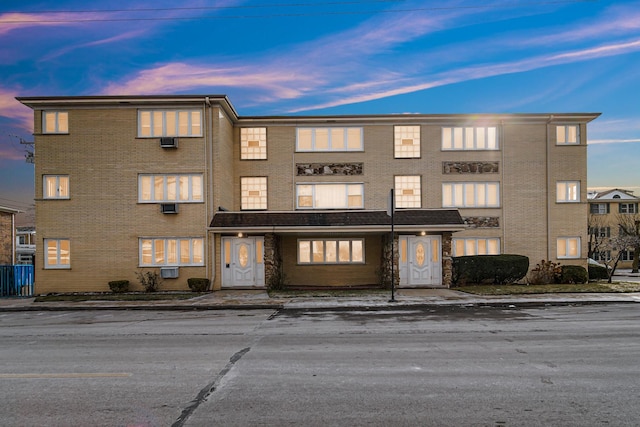 view of outdoor building at dusk