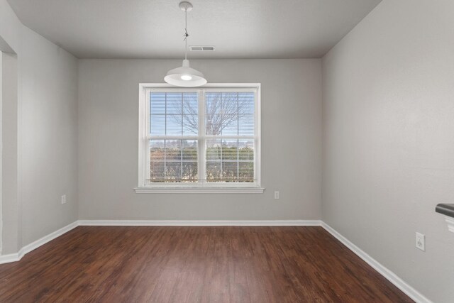 empty room featuring dark wood-type flooring