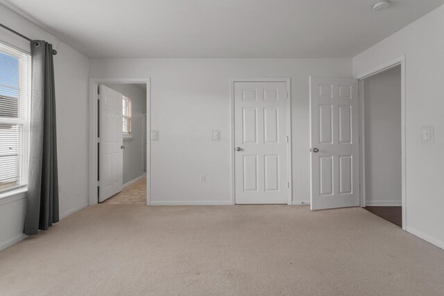 unfurnished bedroom with light carpet