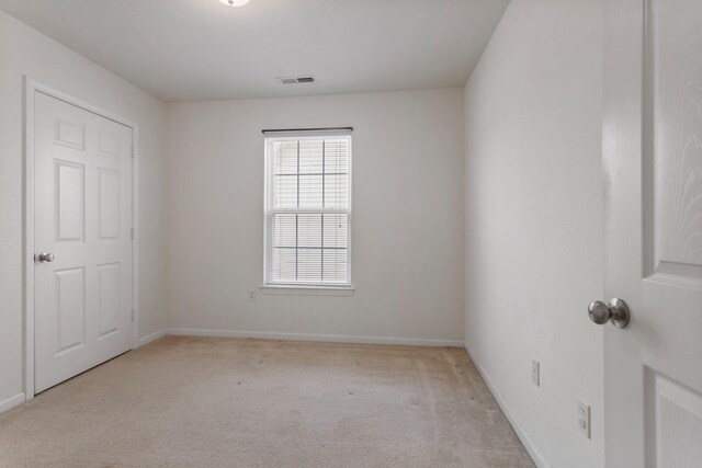 empty room featuring light colored carpet