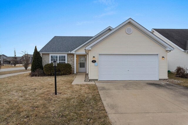 ranch-style home featuring a garage and a front lawn