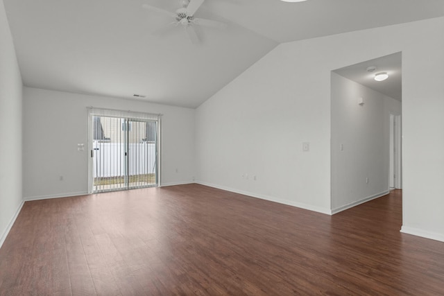 empty room featuring dark hardwood / wood-style flooring, vaulted ceiling, and ceiling fan