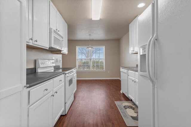 kitchen with white cabinetry, white appliances, pendant lighting, and dark wood-type flooring