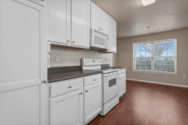 kitchen with pendant lighting, white appliances, dark wood-type flooring, and white cabinets